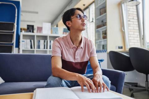 Image of student reading a braille book.