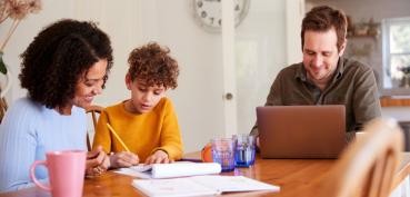 Image of family working together at table